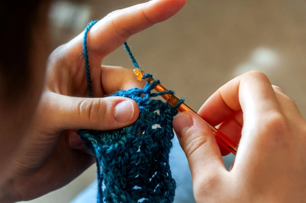 Artisan hands crocheting by hand